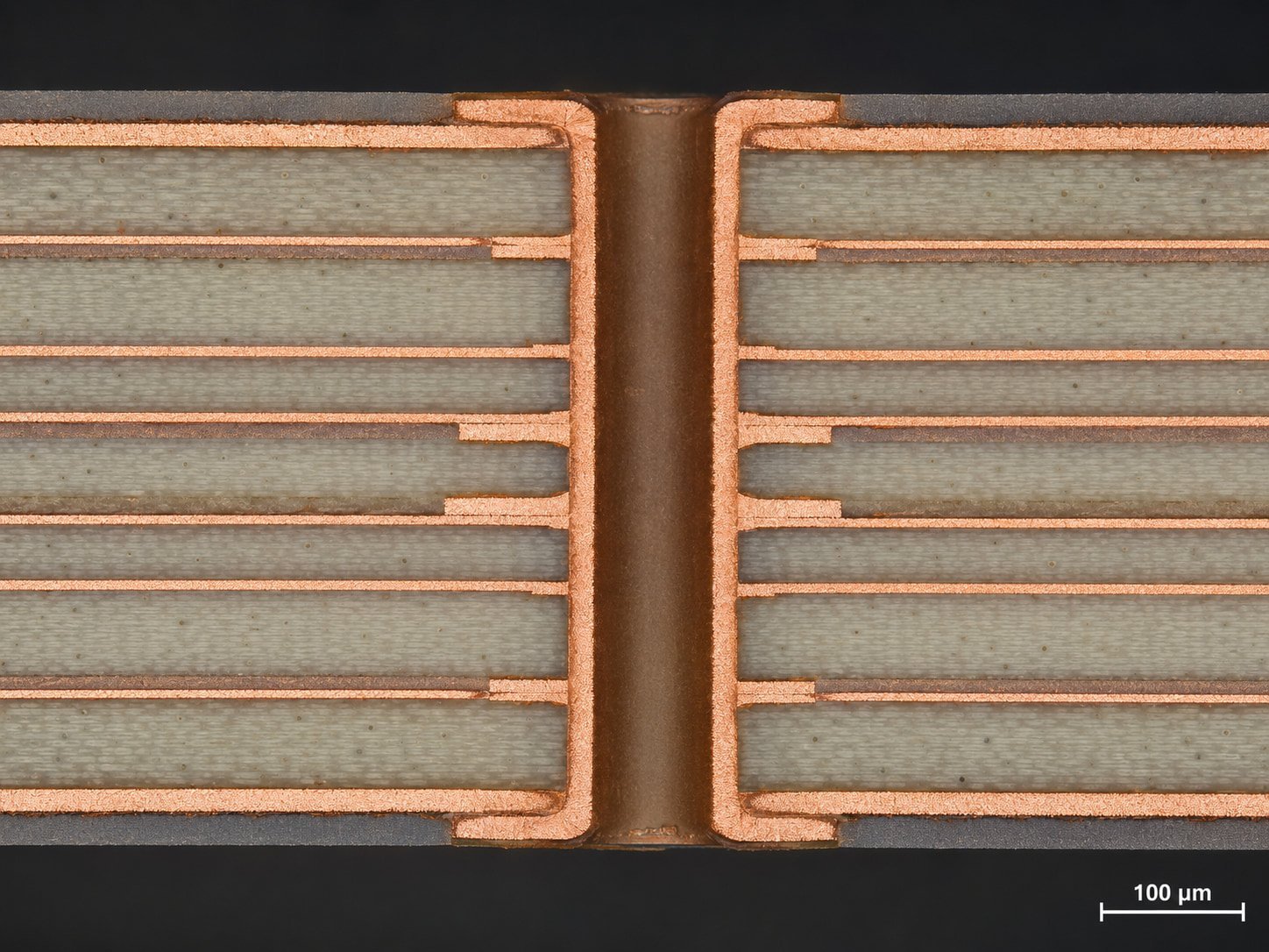 Cross-section micrograph of a multilayer RO4000 PCB showing stable plated through-holes, copper bonding, and dielectric layer structure for high-frequency circuit applications.